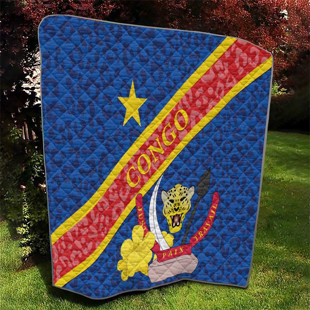 Blue quilted Congo flag blanket featuring yellow star and leopard emblem with diagonal stripe.