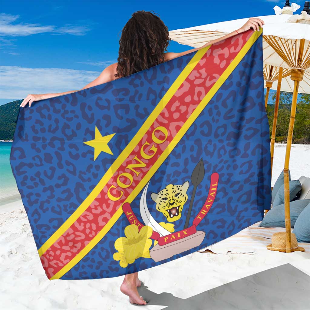 Blue sarong draped with Congo DR text, leopard head emblem, red and yellow diagonal band
