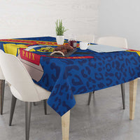 Blue tablecloth draped on dining table with coat of arms leopard-style print
