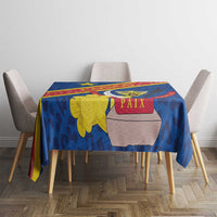 Blue tablecloth with coat of arms and leopard-style pattern, square table view