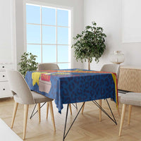 Blue tablecloth on dining table with leopard-style coat of arms graphic panels