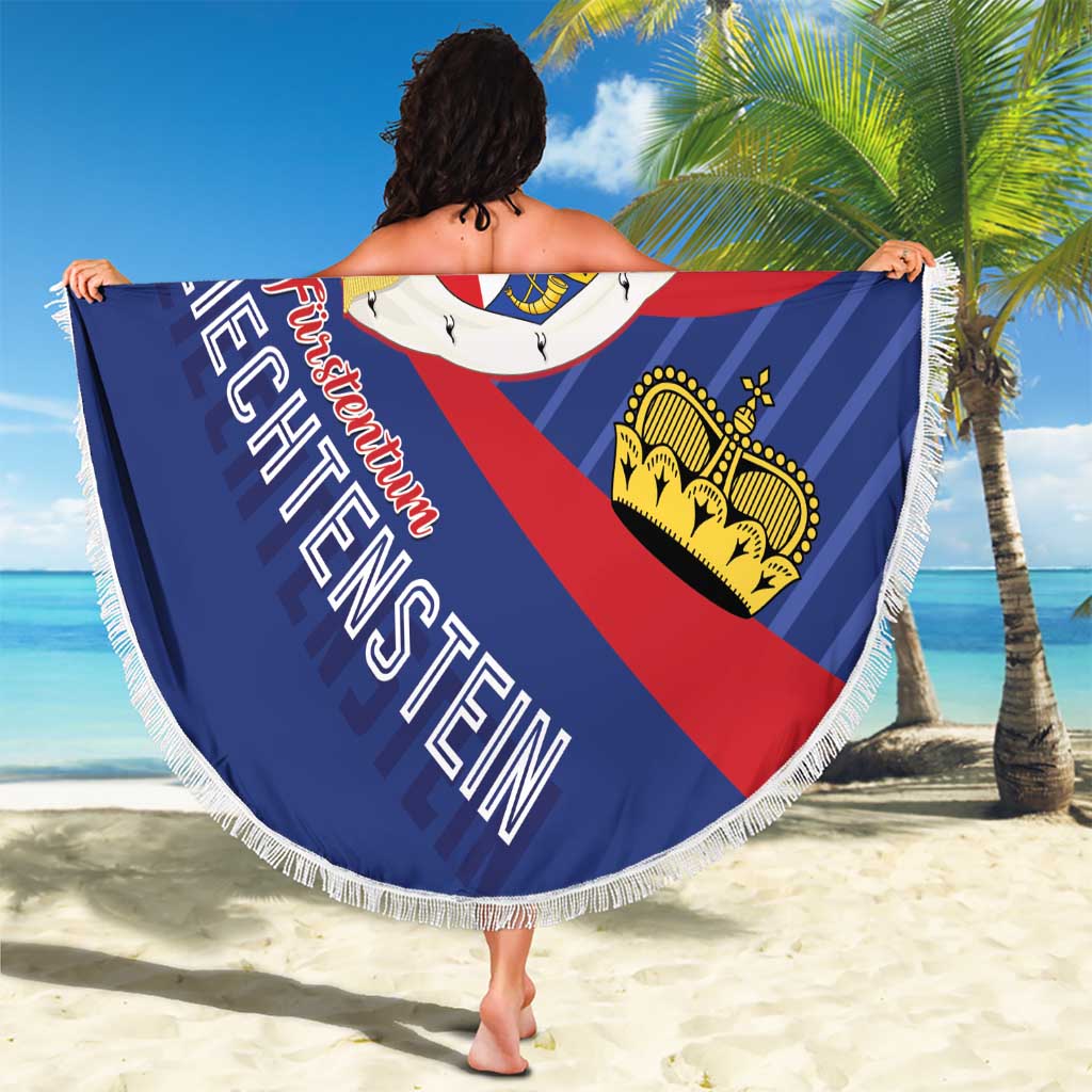 Round beach blanket held outdoors, Liechtenstein crest in blue and red with white fringe