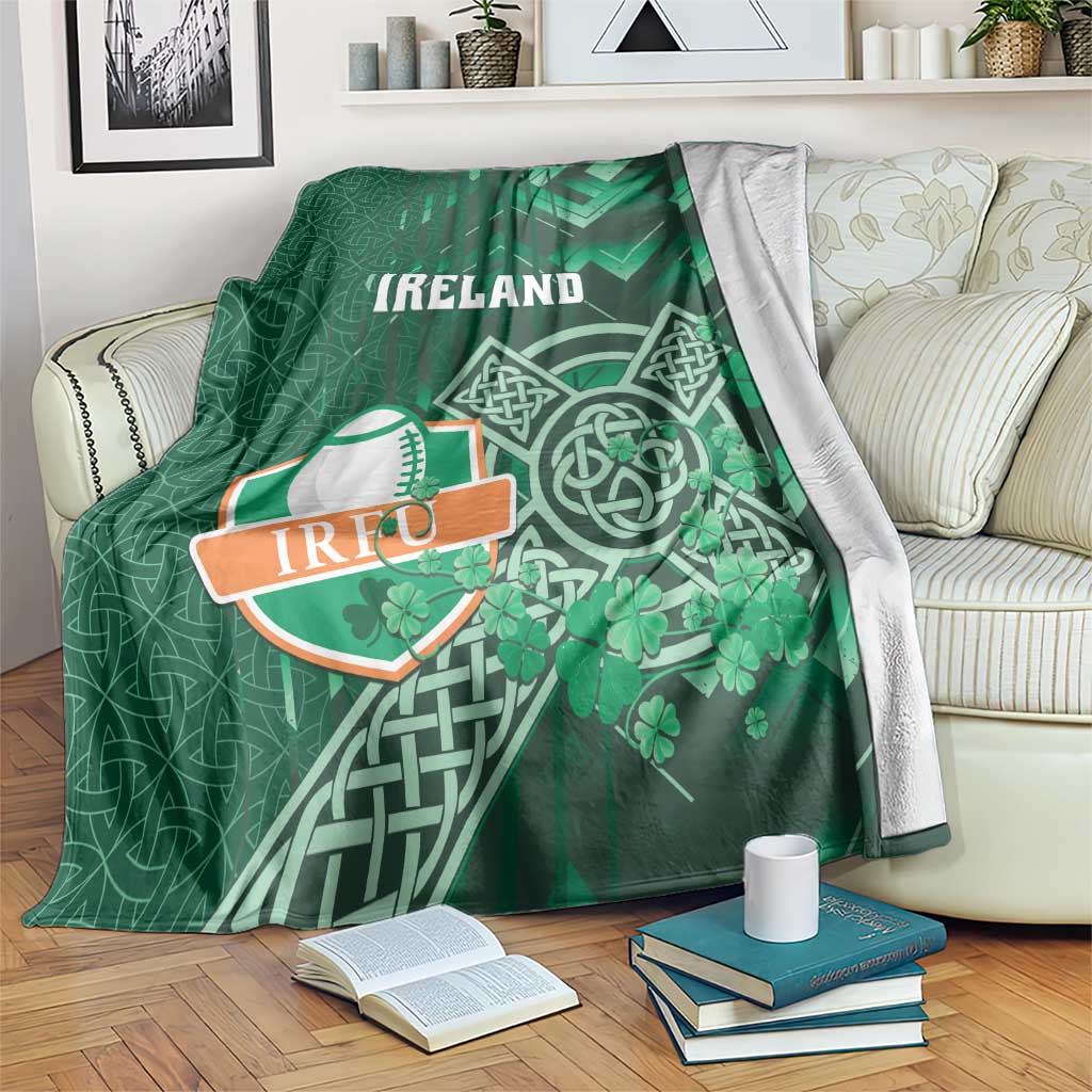 Green Ireland rugby blanket with Celtic knot and shamrock graphic, folded on couch