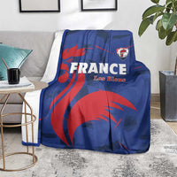 Blue France rugby blanket with red lion graphic and Les Bleus logo, on living-room couch