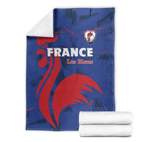 Blue France rugby blanket with red lion mascot print and Les Bleus crest, folded with towels