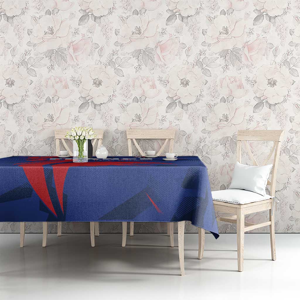 Blue France rugby tablecloth with red and dark navy graphic motif, set on dining table
