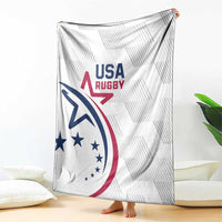White USA Rugby throw blanket with large USA Rugby emblem, draped on floor