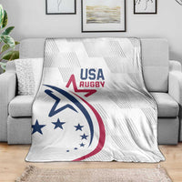 White USA Rugby throw blanket with USA Rugby logo on gray couch