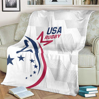 White rugby throw blanket with USA Rugby logo, draped over light sofa