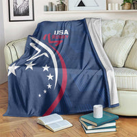 Blue USA Rugby blanket with large eagle and circular stars graphic, on a sofa.