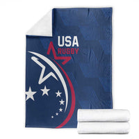 Blue USA Rugby blanket with eagle and stars, packaged with stacked white rolls.