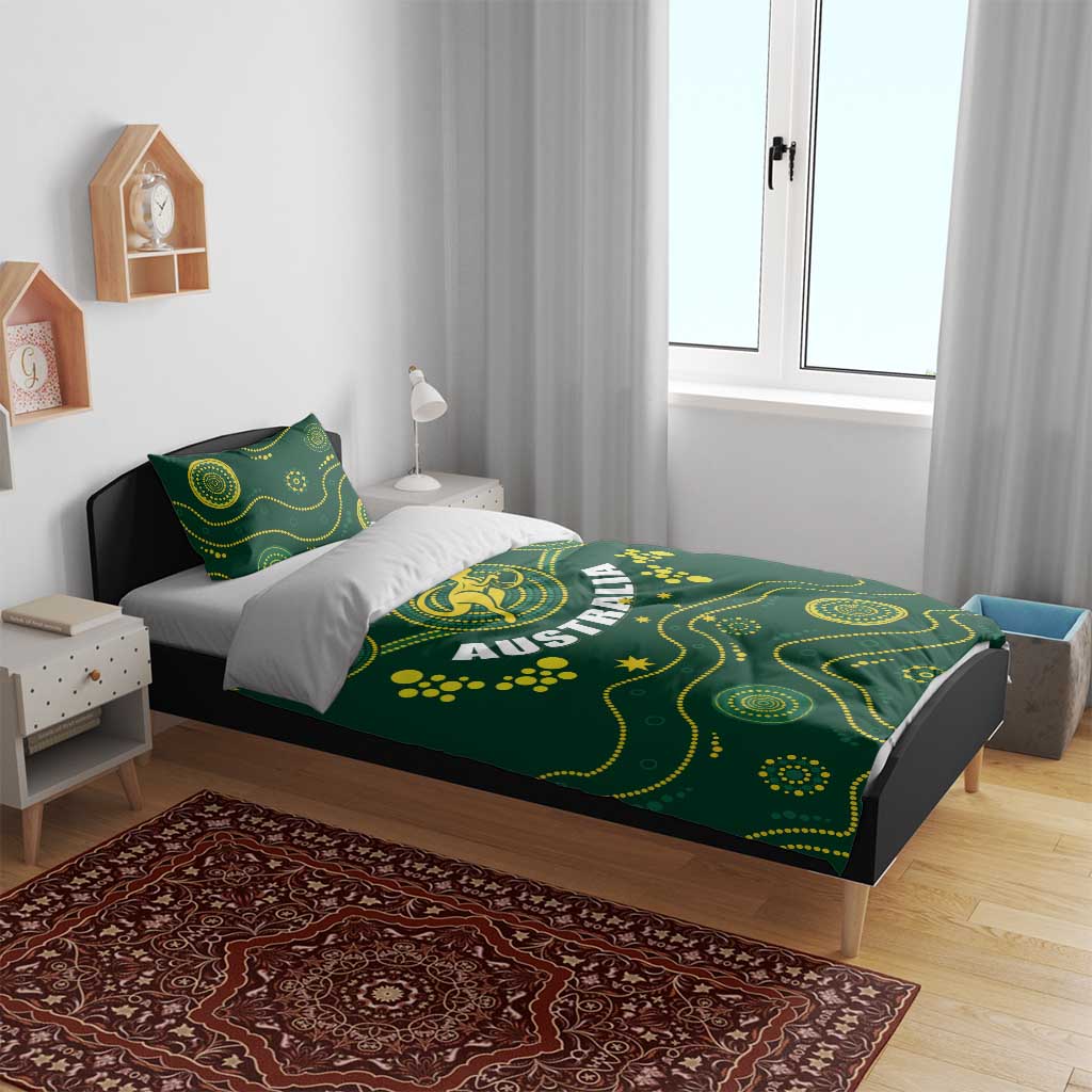 Green duvet cover on a bed with yellow Australia crest and wavy dot pattern