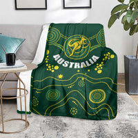 Green Australia rugby blanket with Wallabies kangaroo emblem draped on a sofa