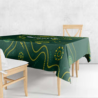 Green rugby tablecloth with yellow swirl and dot graphics, draped over dining bench