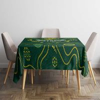 Green rugby tablecloth with yellow pattern and emblem, centered on dining table