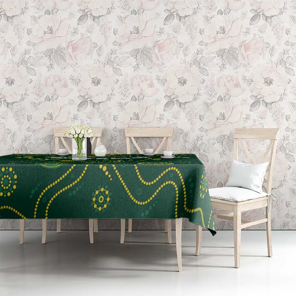 Green rugby tablecloth with yellow patterned motif, laid across a dining table