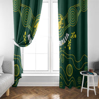 Dark green curtain panels with gold swirl and paw-print pattern flanking a window