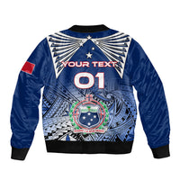 Blue bomber jacket with black ribbed cuffs, back stars, and '01' and crest graphic
