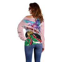 Side view light pink off-shoulder sweater with Kenya graphic print across back