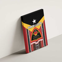 Canvas wall art leaning on a wall with Timor-Leste crest, white star, and multicolor textile pattern