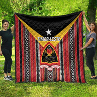 Red and black quilt featuring vertical stripe pattern, white star, and crest graphic