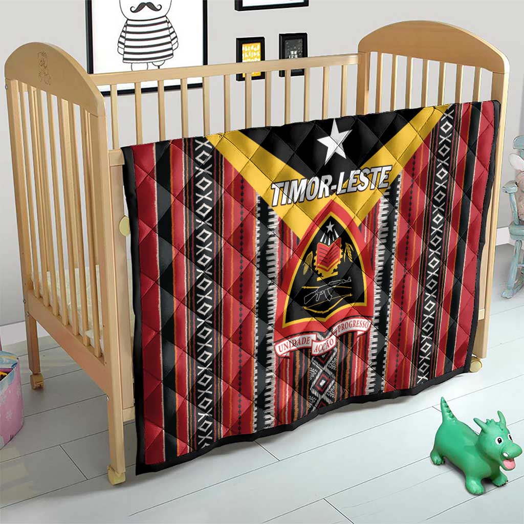Red and black quilt with yellow chevron, white star, and emblem center on a crib