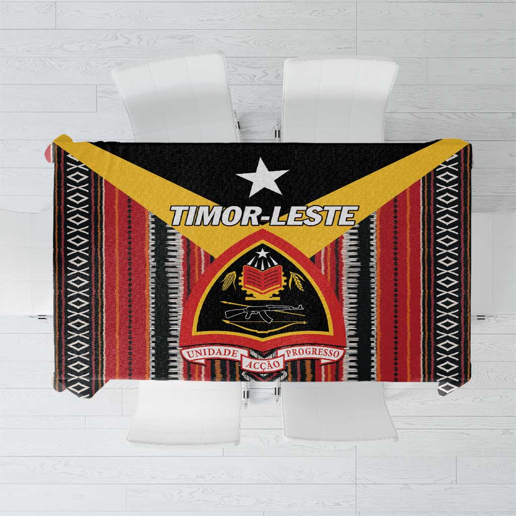 Geometric patterned tablecloth in black, red, and yellow with a central crest design.