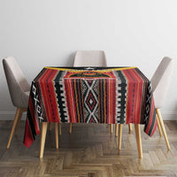 Multicolor patterned tablecloth with vertical stripe panels and diamond motifs, on a dining table.