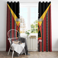 Black window curtain set with red vertical bands and yellow diagonal triangles on each panel