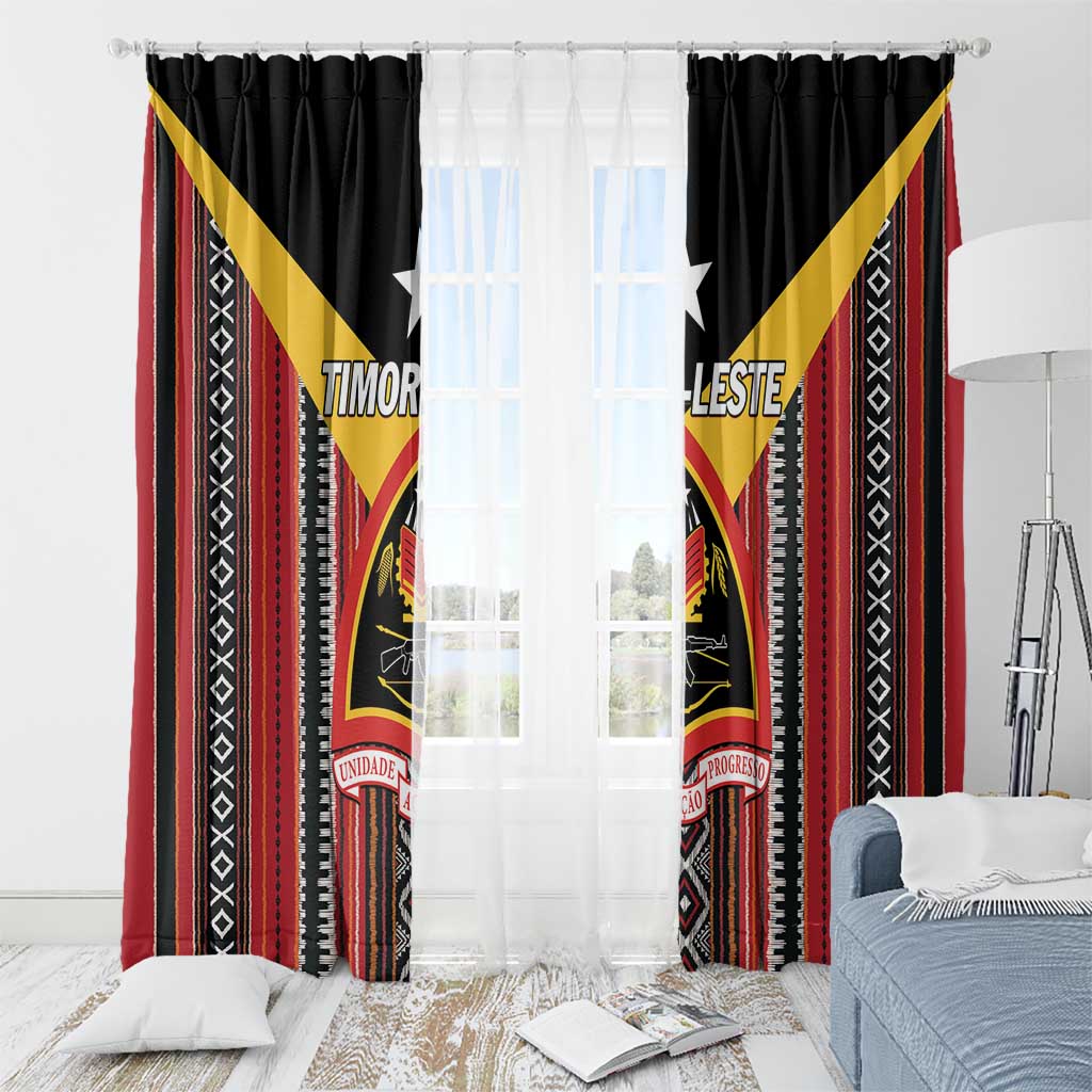 Black window curtain panels with red and yellow patterned design framing sheer light center
