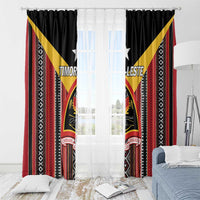 Black window curtain panels with red and yellow patterned design framing sheer light center