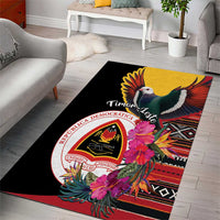 Rectangular black area rug featuring flying bird, pink flowers, and circular crest