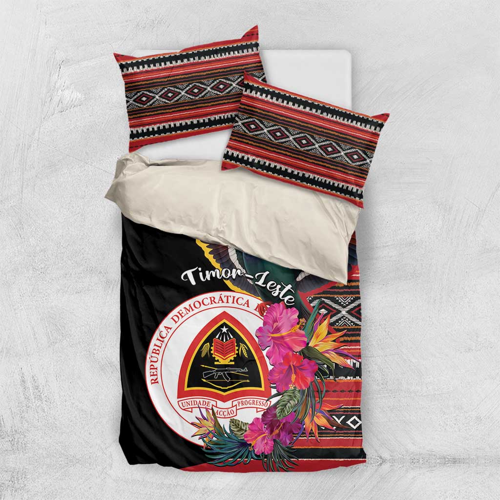 Black duvet cover with folded pillowcases, pigeon, hibiscus flowers, and circular emblem