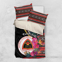 Black duvet cover with folded pillowcases, pigeon, hibiscus flowers, and circular emblem