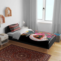 Black duvet cover and pillows on bed, pigeon and floral emblem print with striped accents