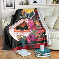 Black blanket with Timor-Leste crest, dove, and hibiscus flower print