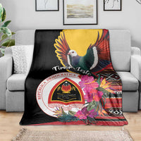 Black throw blanket with dove graphic, Timor-Leste emblem, and colorful floral border
