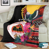 Black blanket featuring dove, Timor-Leste emblem, hibiscus flowers, and geometric trim