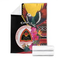 Black folded blanket with dove and Timor-Leste emblem, hibiscus flower and multicolor stripes