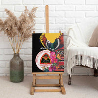 Black canvas wall art on an easel, showing a bird, pink hibiscus flowers, and emblem seal.