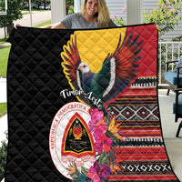 Black quilt with colorful bird, red yellow wings, and floral hibiscus design