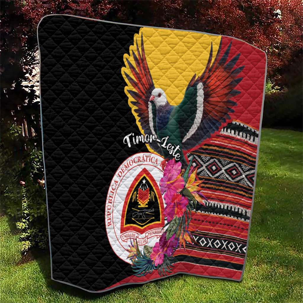Black quilt with large bird and floral hibiscus, red yellow panel, and diamond pattern