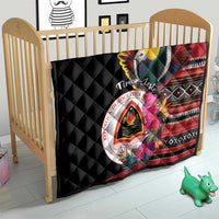 Black quilt on crib with bird graphic, hibiscus flowers, red striped design, and crest