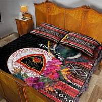 Black quilt bed set with large circular emblem, pigeon and hibiscus, styled with two shams
