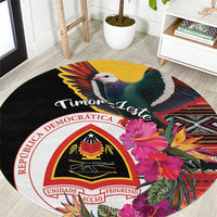 Black round carpet with colorful bird, hibiscus flowers, and national crest graphic