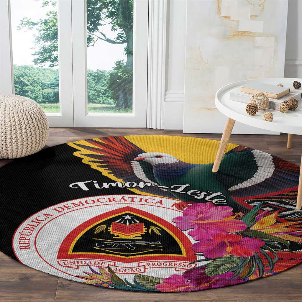 Black round carpet with “Timor-Leste” text, bird, hibiscus flowers, and crest
