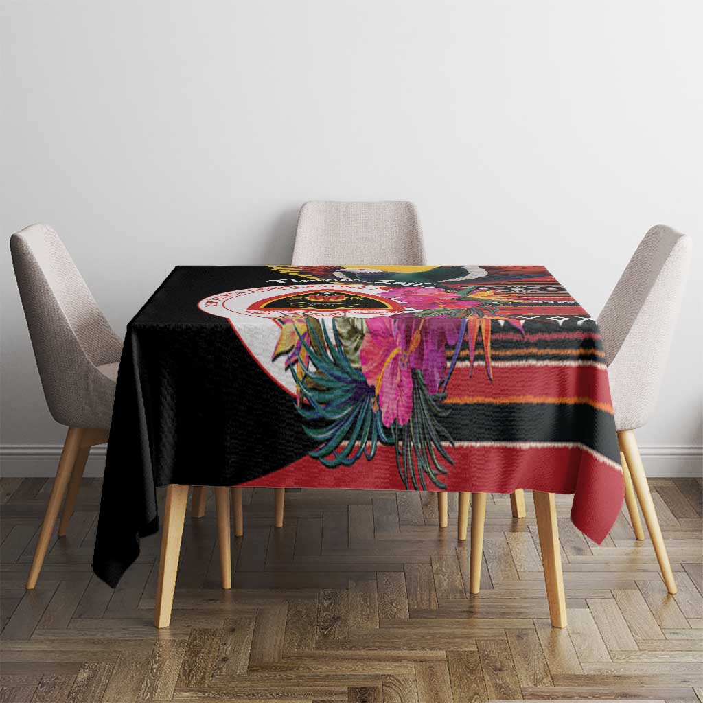 Black tablecloth on dining table with colorful floral bird motif and striped border
