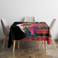 Black tablecloth on dining table with colorful floral bird motif and striped border