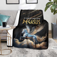 Black Pegasus blanket with winged horse and clouds, laid on gray sofa with side table