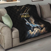 Black quilt with diamond stitching and Pegasus artwork, spread across a sofa
